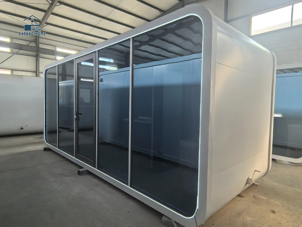 Apple cabinr office pod with glass walls in a warehouse setting
