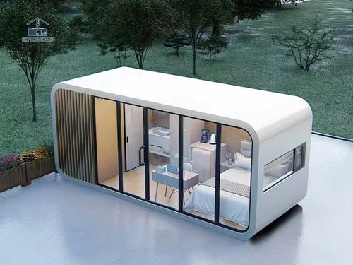 Modern modular home with glass walls on a grassy area