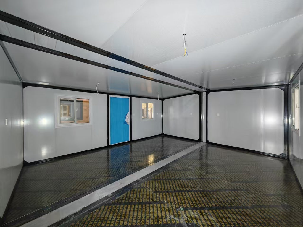 Interior of a mobile home with a blue door and white walls.