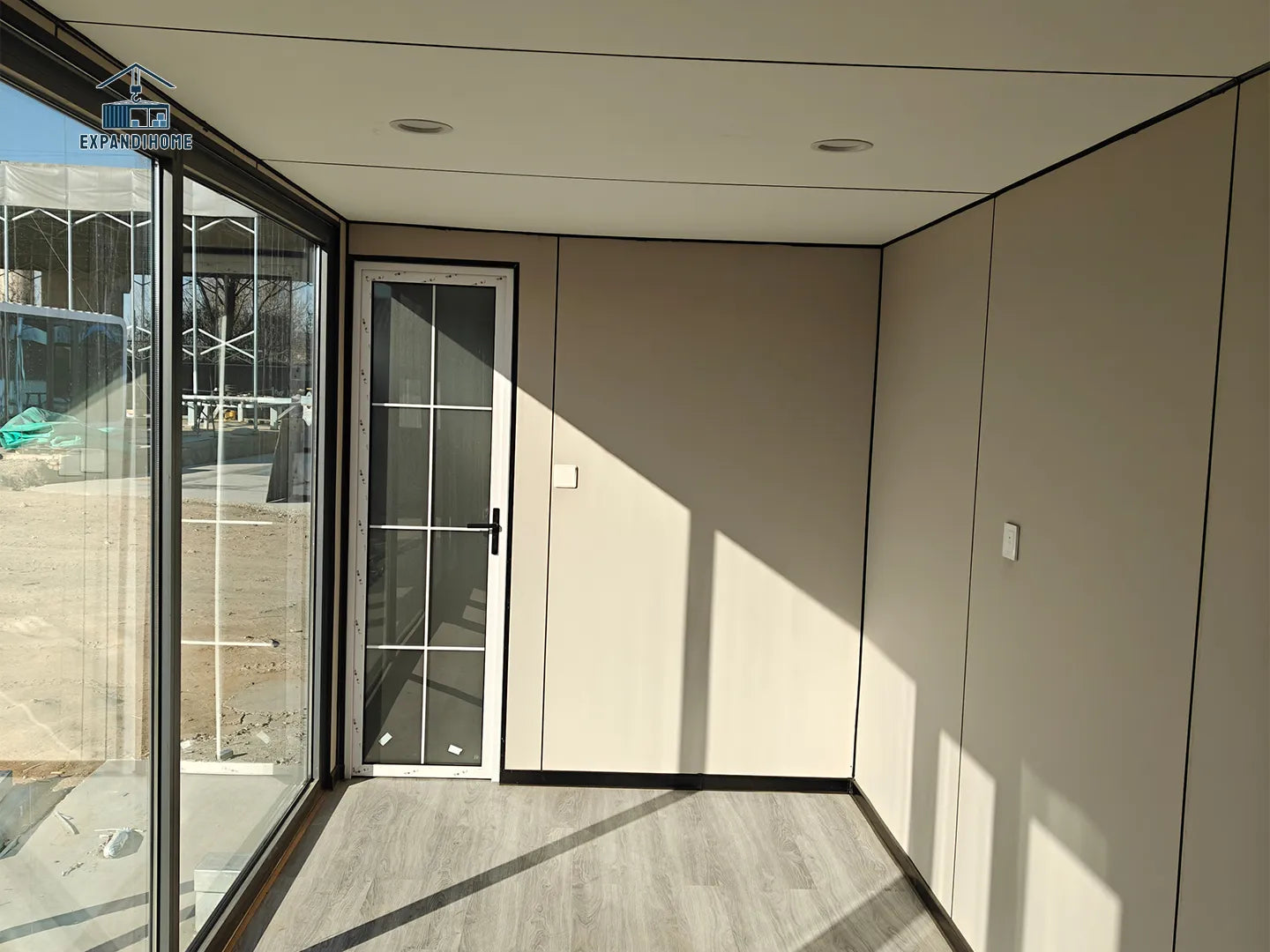 Modern interior with glass door and neutral walls