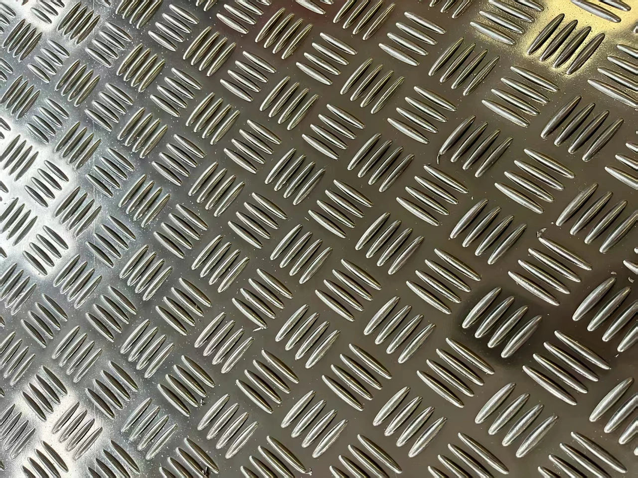 Metallic diamond plate pattern on a brown background HDPE ROAD MATS 2