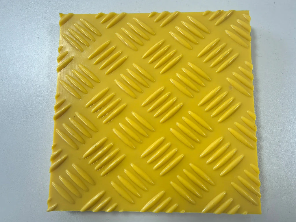 Yellow textured square tile on a light gray background HDPE ROAD MATS 6
