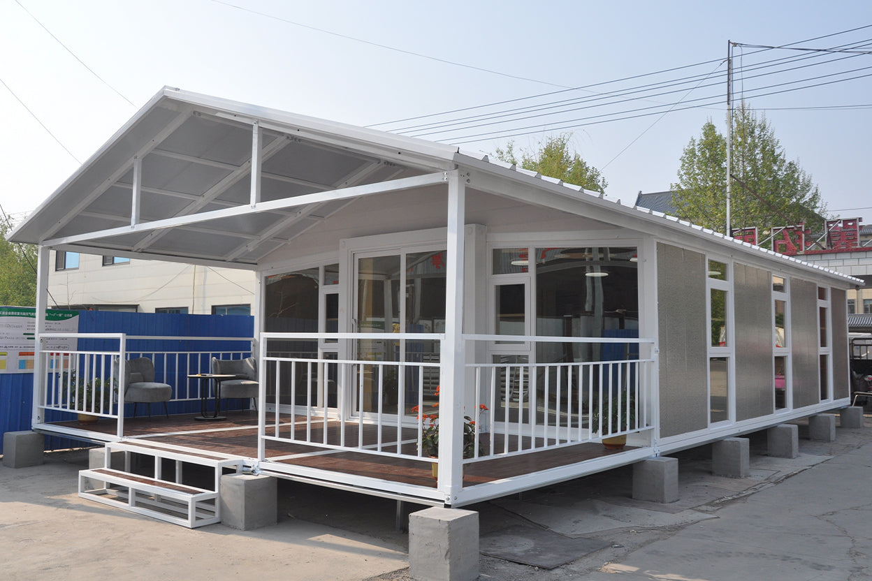 Modular building with a covered porch and glass windows on a clear day.