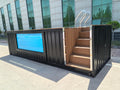 Container with wooden steps leading up to a modern building entrance