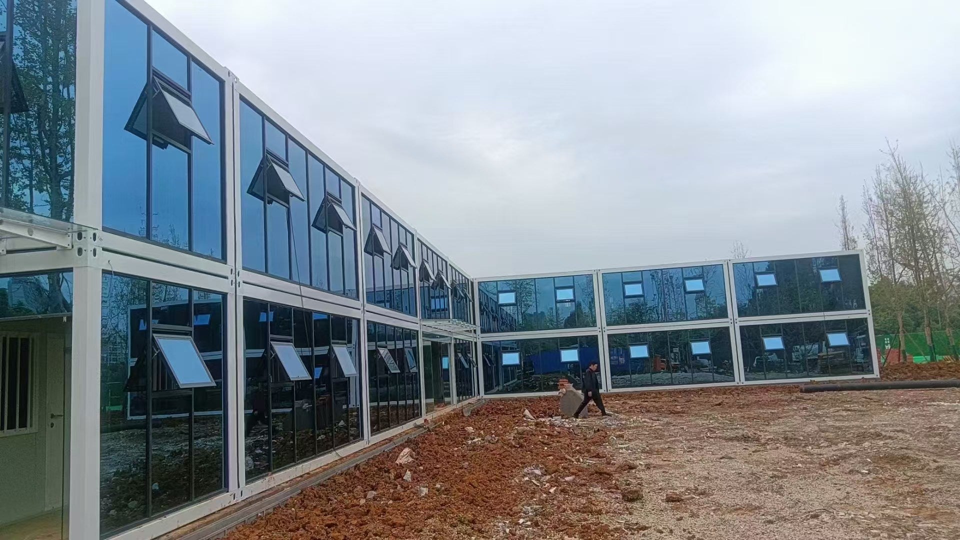 Modern building with glass facade under a cloudy sky