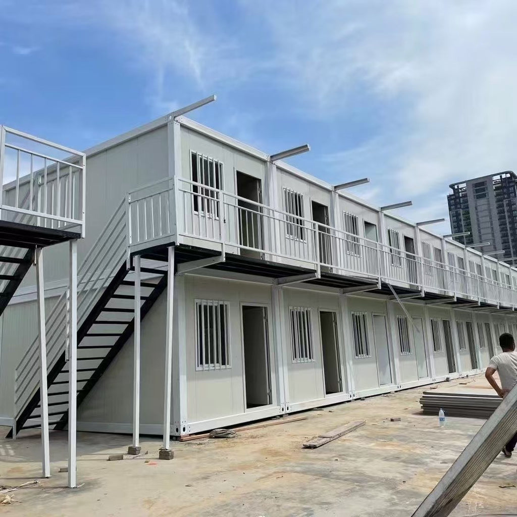Modular building with stairs and railing under a blue sky