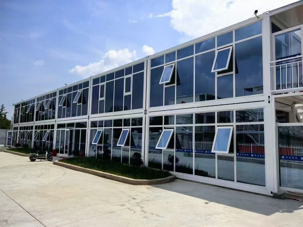 Modern building with large glass windows and a clear blue sky.