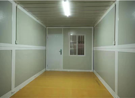 Small room with green walls, a white door, and a window.
